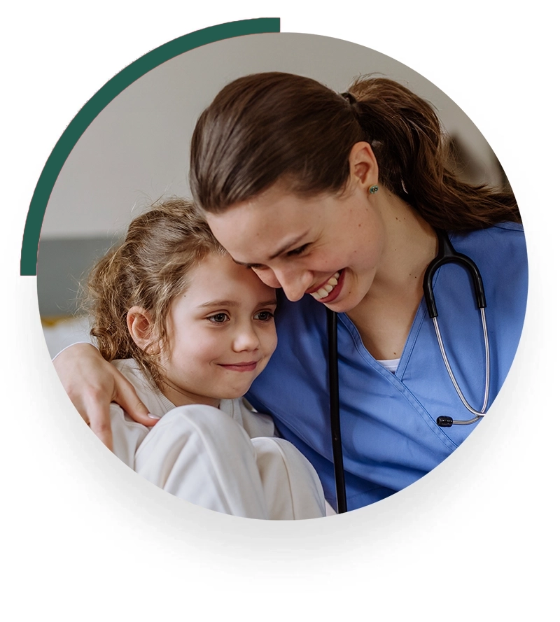 A nurse provides a warm, compassionate hug to a child at home, demonstrating care and empathy. This tender moment illustrates the nurturing approach of in-home healthcare services, enhancing the comfort and well-being of young patients.
