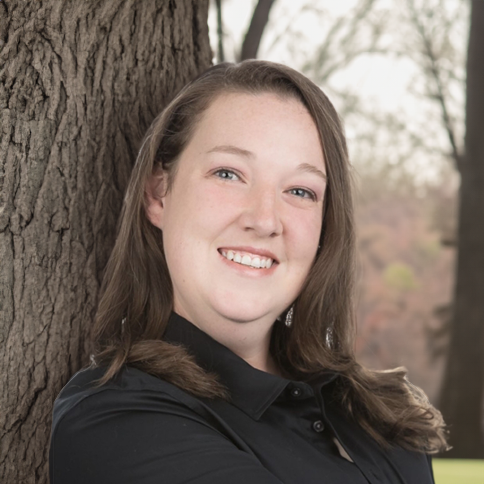 Headshot of Jessica Sanders, a member of the leadership team at At Home Healthcare, featured on the company's leadership page. Jessica is smiling confidently at the camera, wearing professional attire, conveying her role and expertise in the healthcare sector.