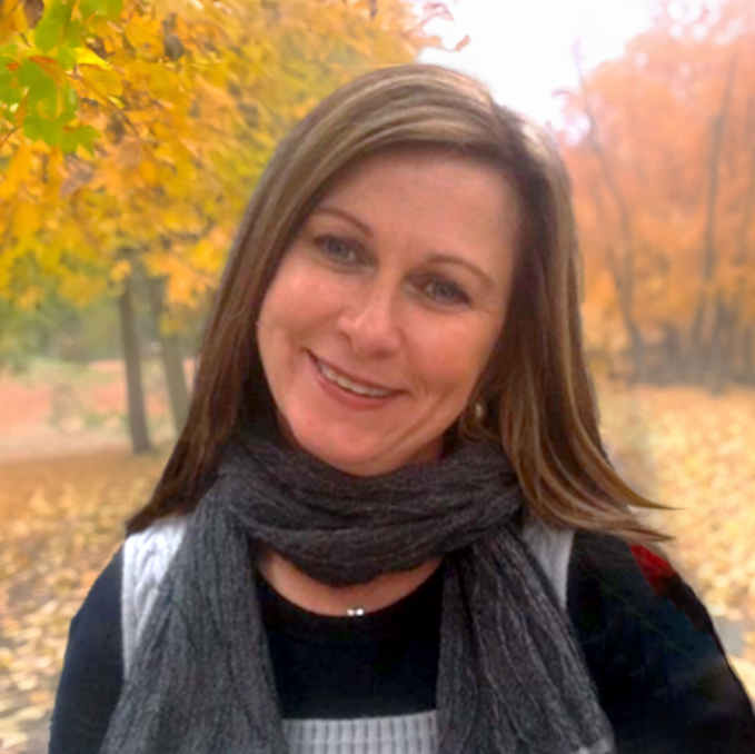 Headshot of Angela Six, a leader at an at-home healthcare service provider, featured on the company's leadership page. Angela is professionally dressed, smiling at the camera with a confident and approachable expression.